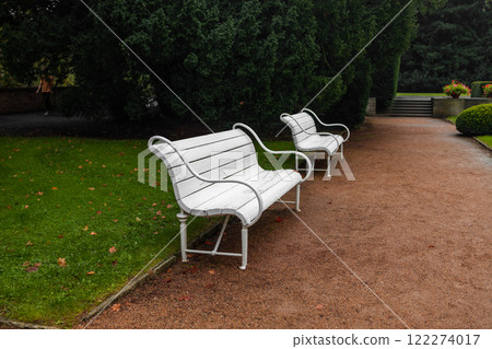 A park with rose flowers and white benches on Petrin Hill above the city. A park with rose flowers and white benches on Petrin Hill above the city. 122274017