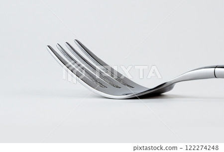 Fork placed on a clean surface ready for a meal Fork placed on a clean surface ready for a meal 122274248