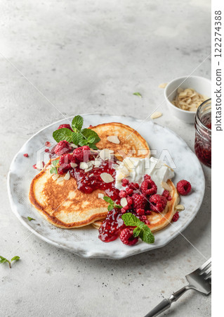 Homemade pancakes with yoghurt, berries and raspberry jam. Maslenitsa or Pancake day breakfast on gray background with copy space Homemade pancakes with yoghurt, berries and raspberry jam. Maslenitsa or Pancake day breakfast on gray background with copy space 122274388