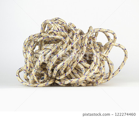 A tangled knot of rope lies on a plain white background with colorful threads A tangled knot of rope lies on a plain white background with colorful threads 122274460