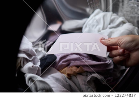 Laundry Process Illustrated with a Hand Gripping a Blank Sheet in the Background Laundry Process Illustrated with a Hand Gripping a Blank Sheet in the Background 122274837