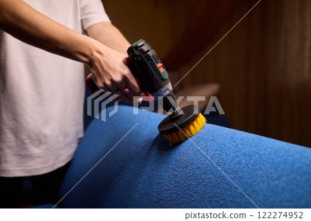 Using a power tool with a brush attachment can effectively clean upholstery furniture and fabrics Using a power tool with a brush attachment can effectively clean upholstery furniture and fabrics 122274952