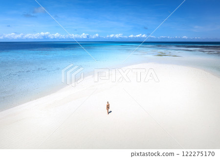 Aerial view of woman, sandbank, white sand, sea in low tide Aerial view of woman, sandbank, white sand, sea in low tide 122275170