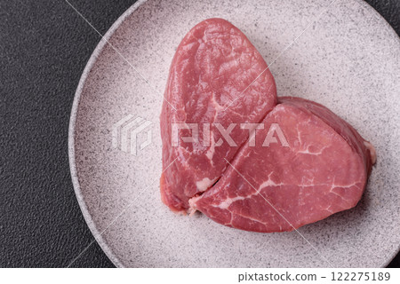Ribeye steak raw with salt, spices and herbs Ribeye steak raw with salt, spices and herbs 122275189