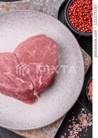 Ribeye steak raw with salt, spices and herbs Ribeye steak raw with salt, spices and herbs 122275193