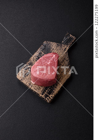 Ribeye steak raw with salt, spices and herbs 122275199