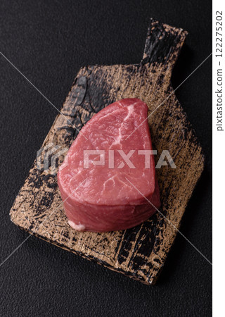Ribeye steak raw with salt, spices and herbs 122275202