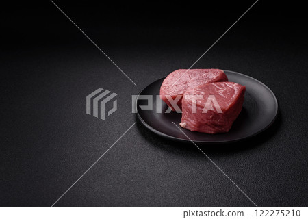 Ribeye steak raw with salt, spices and herbs Ribeye steak raw with salt, spices and herbs 122275210
