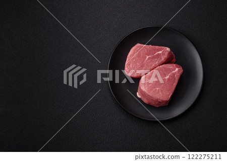 Ribeye steak raw with salt, spices and herbs Ribeye steak raw with salt, spices and herbs 122275211