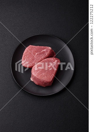 Ribeye steak raw with salt, spices and herbs Ribeye steak raw with salt, spices and herbs 122275212