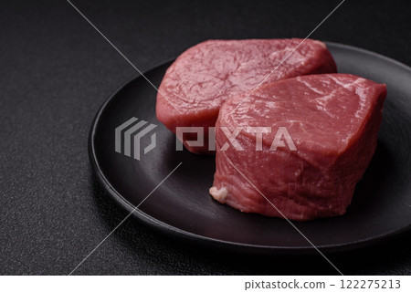 Ribeye steak raw with salt, spices and herbs 122275213