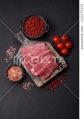 Juicy beef cut into slices with salt, spices and herbs 122275233