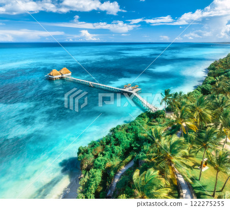 Aerial view of bungalow, white sandy beach, sea and palms Aerial view of bungalow, white sandy beach, sea and palms 122275255