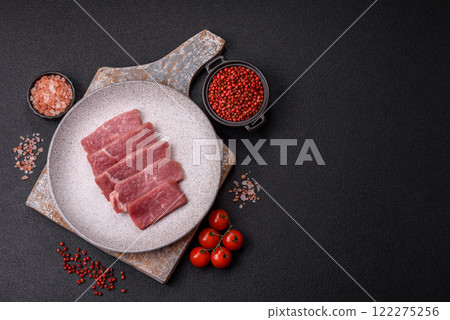 Juicy beef cut into slices with salt, spices and herbs 122275256