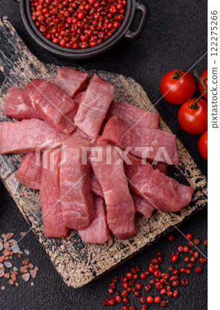 Juicy beef cut into slices with salt, spices and herbs Juicy beef cut into slices with salt, spices and herbs 122275266