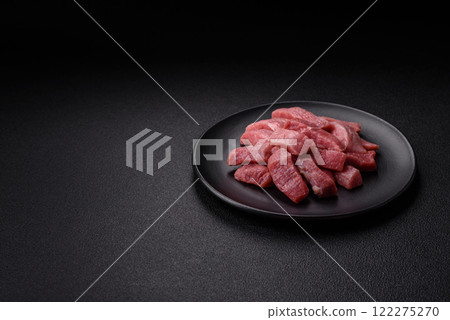 Juicy beef cut into slices with salt, spices and herbs Juicy beef cut into slices with salt, spices and herbs 122275270