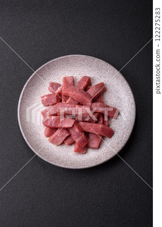 Juicy beef cut into slices with salt, spices and herbs 122275283