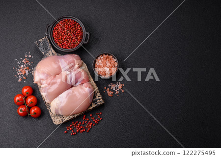 Fresh raw chicken thigh fillets with salt, spices and herbs 122275495