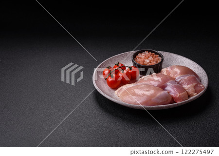 Fresh raw chicken thigh fillets with salt, spices and herbs 122275497