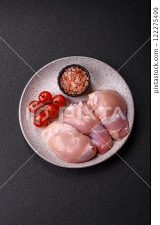 Fresh raw chicken thigh fillets with salt, spices and herbs Fresh raw chicken thigh fillets with salt, spices and herbs 122275499