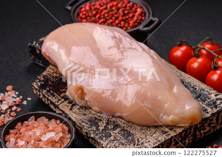 Pieces of raw chicken or turkey fillet with salt, spices and herbs Pieces of raw chicken or turkey fillet with salt, spices and herbs 122275527