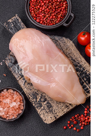 Pieces of raw chicken or turkey fillet with salt, spices and herbs 122275529