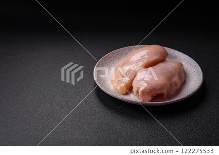 Pieces of raw chicken or turkey fillet with salt, spices and herbs Pieces of raw chicken or turkey fillet with salt, spices and herbs 122275533