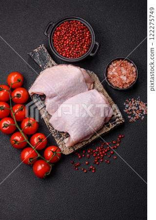 Raw chicken thighs with salt, spices and herbs 122275749