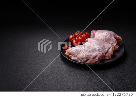 Raw chicken thighs with salt, spices and herbs 122275750