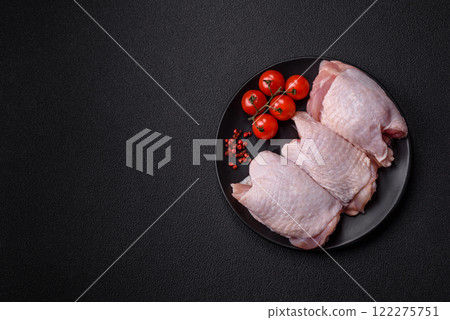 Raw chicken thighs with salt, spices and herbs Raw chicken thighs with salt, spices and herbs 122275751
