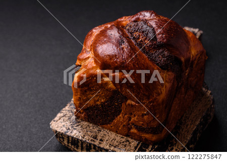 Sweet poppy seed cake on a dark concrete background 122275847