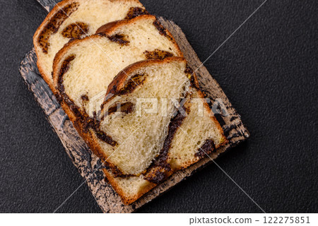 Sweet poppy seed cake on a dark concrete background 122275851