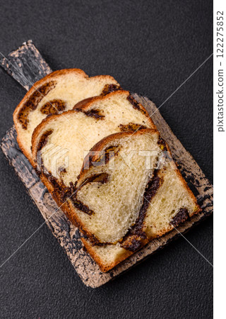 Sweet poppy seed cake on a dark concrete background Sweet poppy seed cake on a dark concrete background 122275852