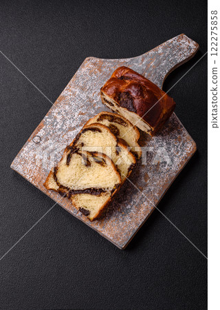 Sweet poppy seed cake on a dark concrete background Sweet poppy seed cake on a dark concrete background 122275858