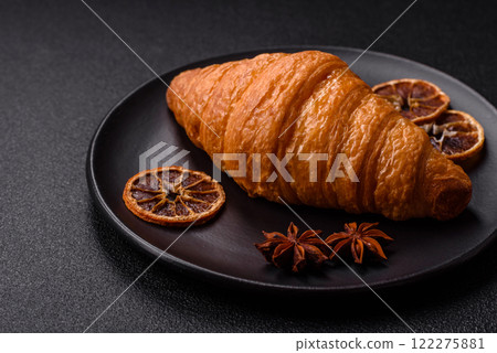 Golden crispy croissant with a sweet creamy fruit filling Golden crispy croissant with a sweet creamy fruit filling 122275881