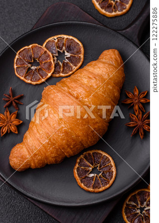 Golden crispy croissant with a sweet creamy fruit filling Golden crispy croissant with a sweet creamy fruit filling 122275886