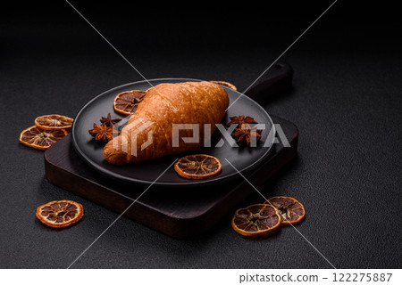 Golden crispy croissant with a sweet creamy fruit filling Golden crispy croissant with a sweet creamy fruit filling 122275887