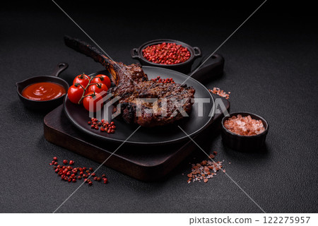 Grilled wagyu beef tomahawk steak with salt, spices and herbs Grilled wagyu beef tomahawk steak with salt, spices and herbs 122275957