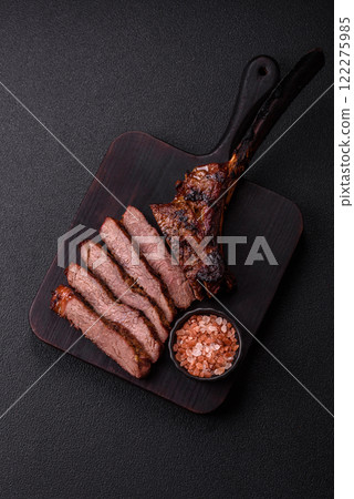 Grilled wagyu beef tomahawk steak with salt, spices and herbs Grilled wagyu beef tomahawk steak with salt, spices and herbs 122275985