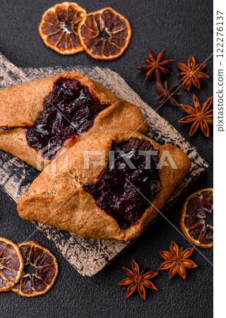 Sweet rye pies with cherries and chocolate 122276137
