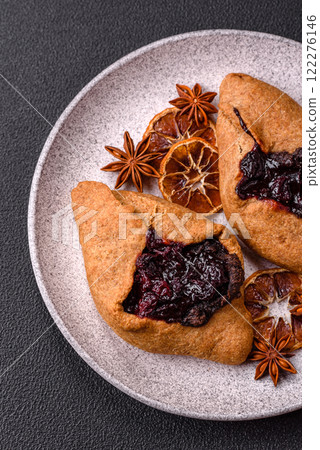 Sweet rye pies with cherries and chocolate Sweet rye pies with cherries and chocolate 122276146