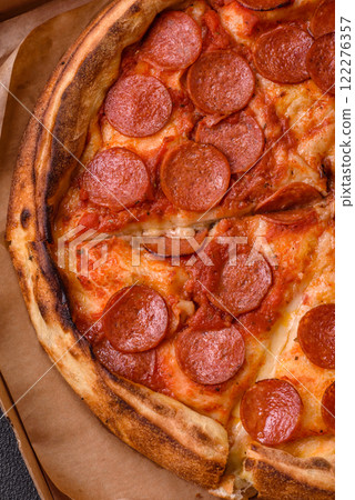 Pepperoni pizza with sausage, mozzarella cheese, tomatoes, salt and spices 122276357
