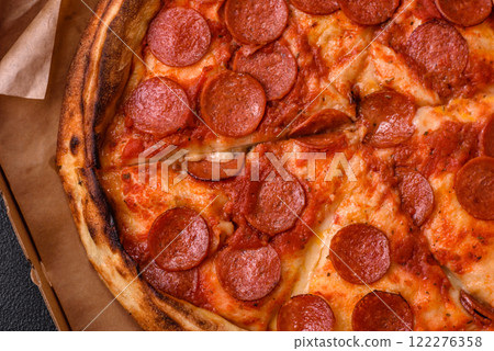 Pepperoni pizza with sausage, mozzarella cheese, tomatoes, salt and spices 122276358