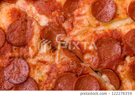 Pepperoni pizza with sausage, mozzarella cheese, tomatoes, salt and spices 122276359