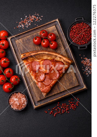 Pepperoni pizza with sausage, mozzarella cheese, tomatoes, salt and spices 122276375