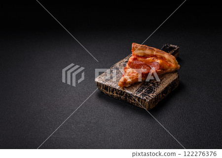 Pepperoni pizza with sausage, mozzarella cheese, tomatoes, salt and spices Pepperoni pizza with sausage, mozzarella cheese, tomatoes, salt and spices 122276376