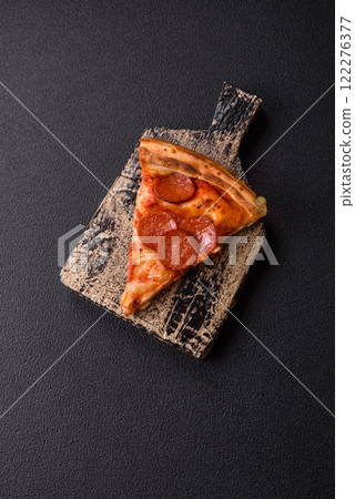 Pepperoni pizza with sausage, mozzarella cheese, tomatoes, salt and spices Pepperoni pizza with sausage, mozzarella cheese, tomatoes, salt and spices 122276377