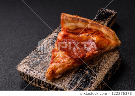 Pepperoni pizza with sausage, mozzarella cheese, tomatoes, salt and spices 122276378