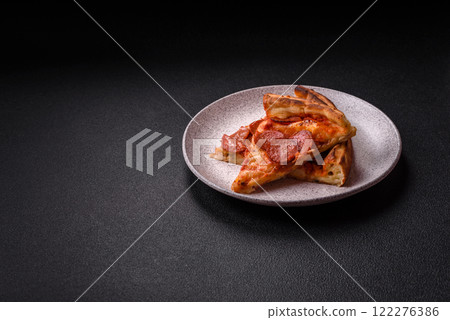 Pepperoni pizza with sausage, mozzarella cheese, tomatoes, salt and spices 122276386