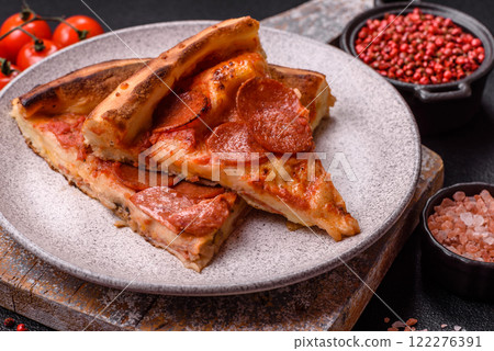 Pepperoni pizza with sausage, mozzarella cheese, tomatoes, salt and spices Pepperoni pizza with sausage, mozzarella cheese, tomatoes, salt and spices 122276391
